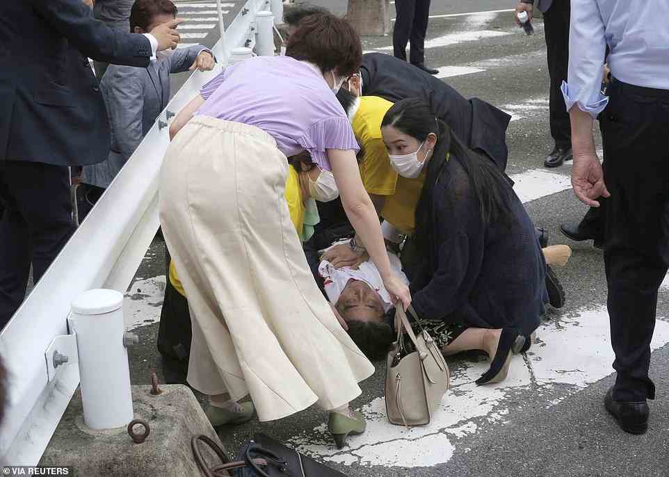 Former Japanese prime minister Shinzo Abe lies on the ground after apparent shooting during an election campaign for the July 10, 2022