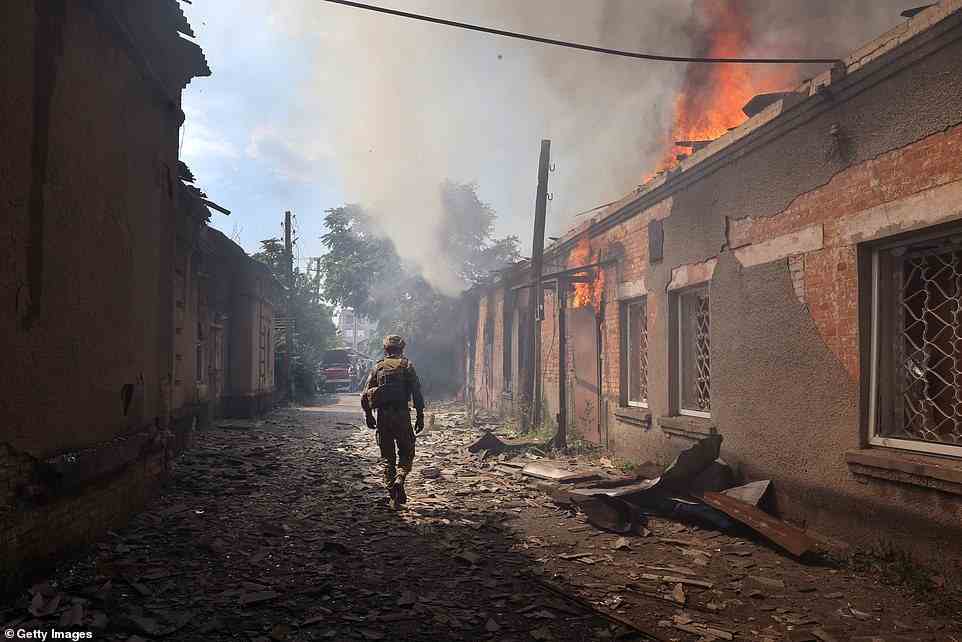 Fire burns at a shopping mall after it was struck by a missile in Sloviansk as Russia steps up its assault on the Donetsk region after seizing Luhansk