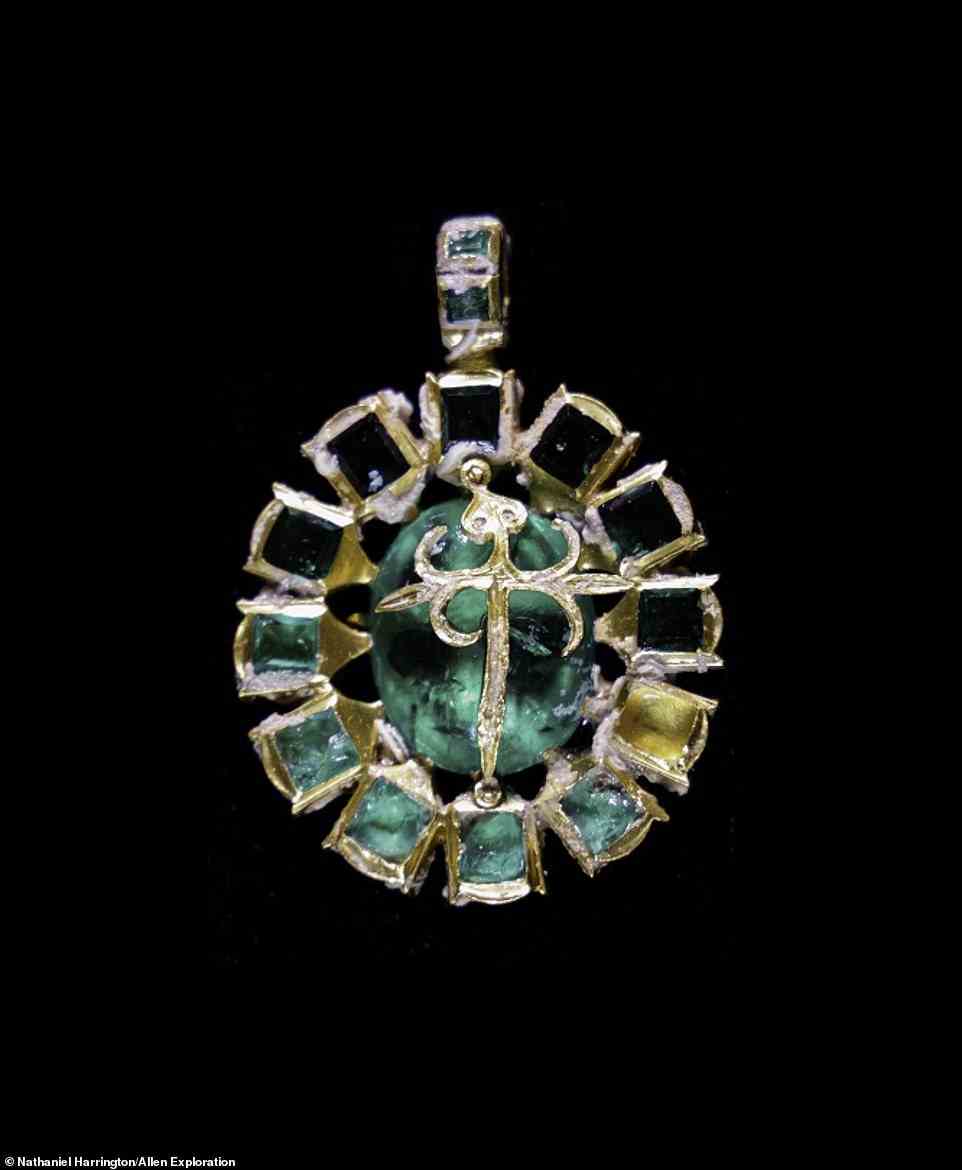 A second golden pendant found on the Maravillas' debris trail is oval in shape and 4.7 centimeters long. At its center a gold Cross of St. James overlies a large green oval Colombian emerald. The outer edge is framed by 12 more square emeralds, perhaps symbolizing the 12 apostles