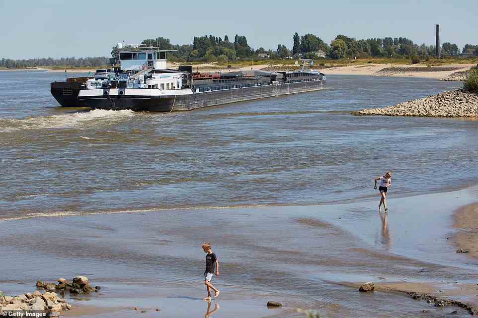 Barges navigate the Waal river amid the ongoing drought and the recurring heat waves which have cut operation capacities by half along the lower Rhine