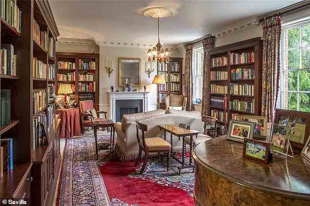 There are also three annexes ¿ each with a gated entrance ¿ in the 26 acres of grounds, providing accommodation for staff or guests. A library is pictured above filled with shelves of books