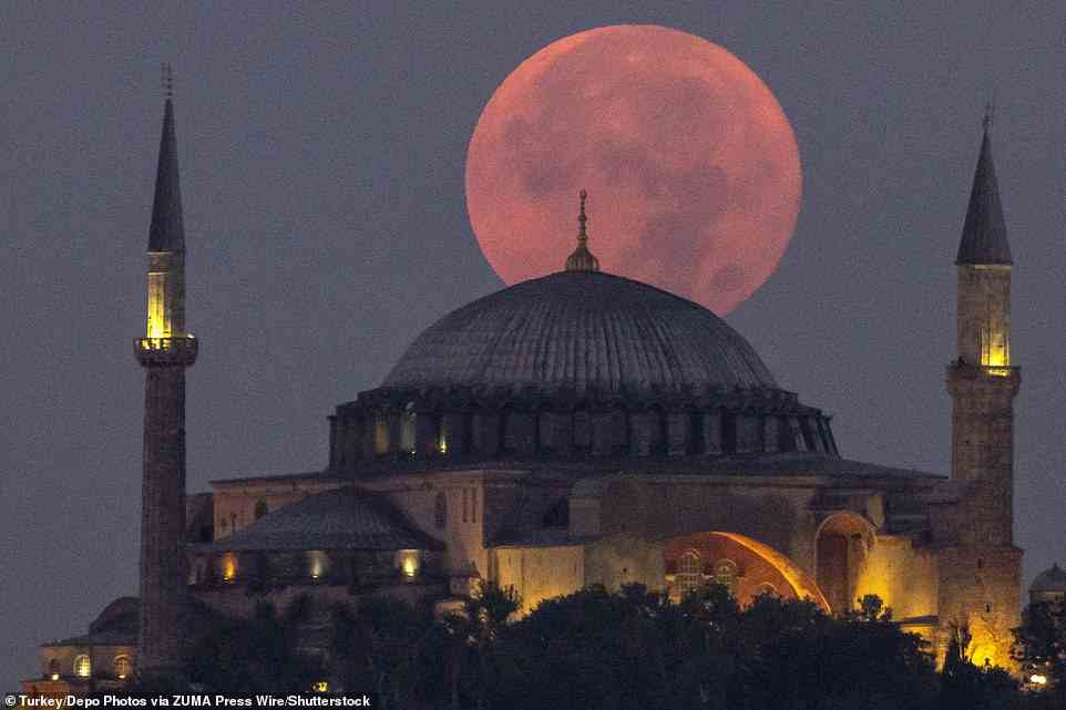 The supermoon dominates the skyline over the Hagia Sophia Mosque in Istanbul, Turkey last night. Supermoons occur because the moon orbits the Earth on an elliptical path, rather than a circular one - meaning its distance from Earth changes
