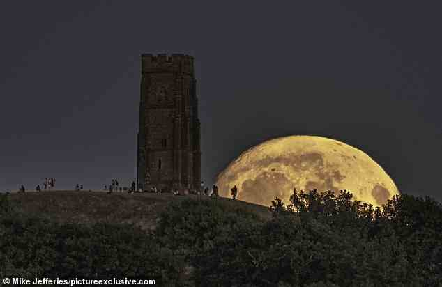 Pictured is the moon rising behind Glastonbury Tor in Somerset on Wednesday evening (August 10). The moon was at 96 per cent illumination on Wednesday night. When it reaches 100 per cent illumination on Thursday night it will be a full moon. The moon will also be a supermoon tonight, because it marks the point in the orbit of the moon at which it is nearest to the Earth