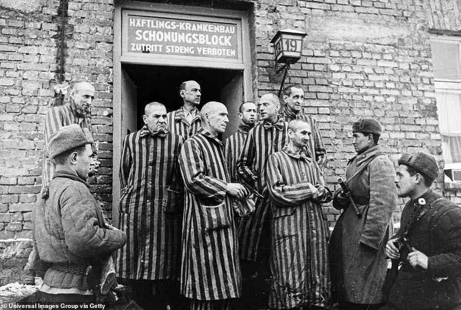 Soviet soldiers are pictured with liberated Auschwitz prisoners in 1945. Eichmann was responsible for making the trains to the death camps run on time