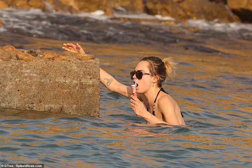 Hold on tight: Cara didn't want to let go of her ice lolly while swimming