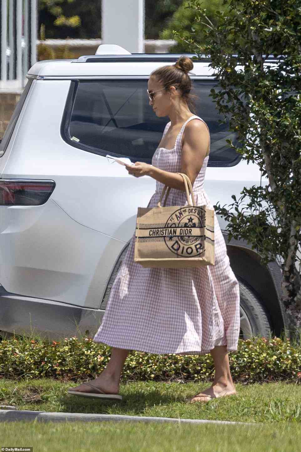 J.Lo arrived carrying a Dior bag, downcast and wearing a summer dress after the medical emergency at the property where she and Ben are celebrating their lavish wedding this weekend