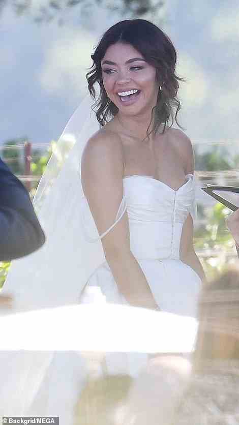 Hyland looked lovely in a shoulder-less white wedding gown with diamond earrings and her brown tresses parted