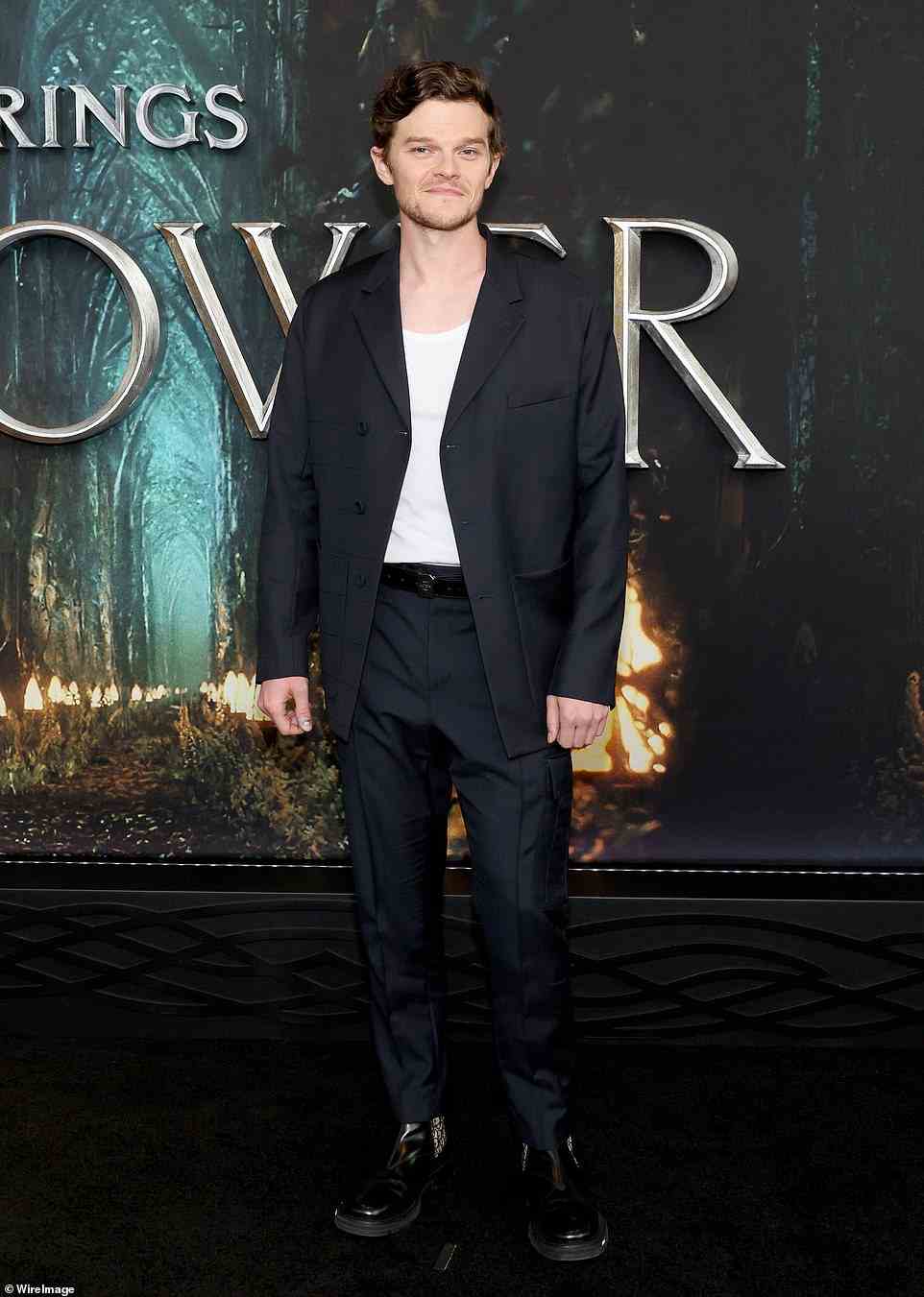 Key character: Robert Aramayo - rocking a white tank beneath a black suit - takes over the role of half-Elf Elrond from SAG Award winner Hugo Weaving, who starred in the Peter Jackson films