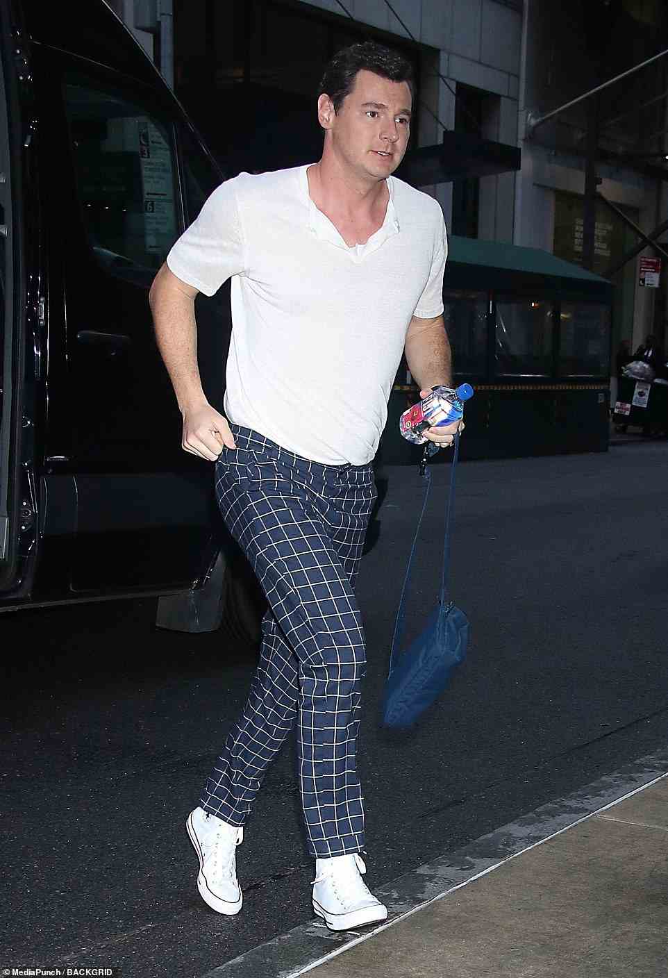 Stylish: Ben Walker rocked a pair of navy blue patterned pants styled with white Converse sneakers and V-neck tee