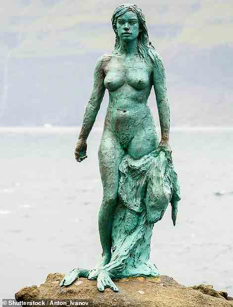 The ¿Seal Woman¿ sculpture on the isle of Kalsoy is framed by spectacular wild scenery