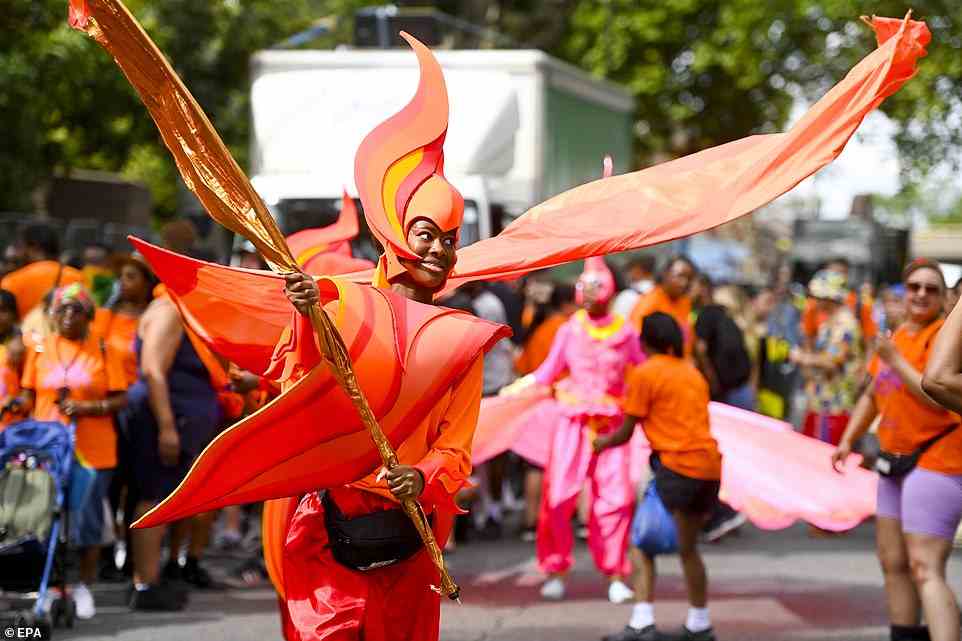 Young people enjoy performing in eyecatching, fire-styled costumes as thousands line the street to watch