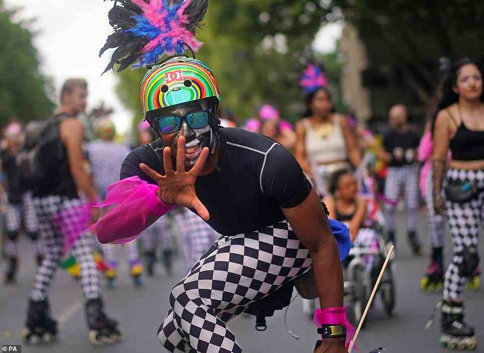 Rollerskaters joined in the parade through Notting Hill today, decorated with glitter and pops of colour