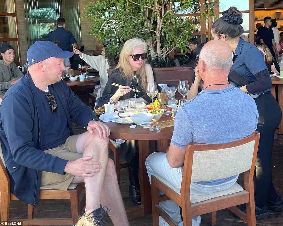 Sanchez sat between Bezos and her friend Laura at the small four-top table located on the patio