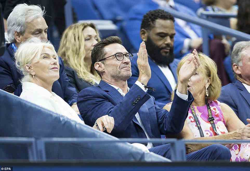 Actor Hugh Jackman (C) watches Serena Williams play Danka Kovinic of Montenegro in their first-round match