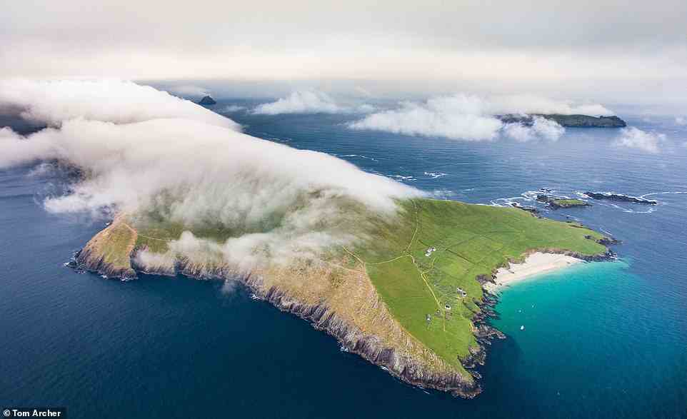 This stunning aerial shot shows Great Blasket in County Kerry, one of six main islands comprising the Blasket archipelago. The outcrop, which measures four miles (6.4km) long and half-a-mile (0.8km) wide, claims the title of being the most westerly point in Europe. According to rucsacs.com, the Blasket Islands were 'inhabited for many centuries, probably since the Iron Age' and Great Blasket had 'a population of some 160 people during World War I, but this soon dwindled and the island was finally abandoned in 1953'. Today Great Blasket is a popular destination for daytrippers, with draws including a white sand beach called Tra Ban (above), which translates to 'White Strand', hiking trails and an abundance of wildlife, ranging from basking sharks to puffins. Visitors can explore the abandoned fishing village on the island and stay in cottages that have been restored and converted into lodgings. Manuel S wrote a review on Tripadvisor after visiting Great Blasket in 2019: 'Silence, donkeys, seals and cliffs. Every minute feels like an hour. The perfect place to breathe and be happy!' To get there, a ferry service from the mainland runs on a seasonal basis from Ce Dhun Chaoin (Dunquin Pier), Dingle Marina and Ventry Pier