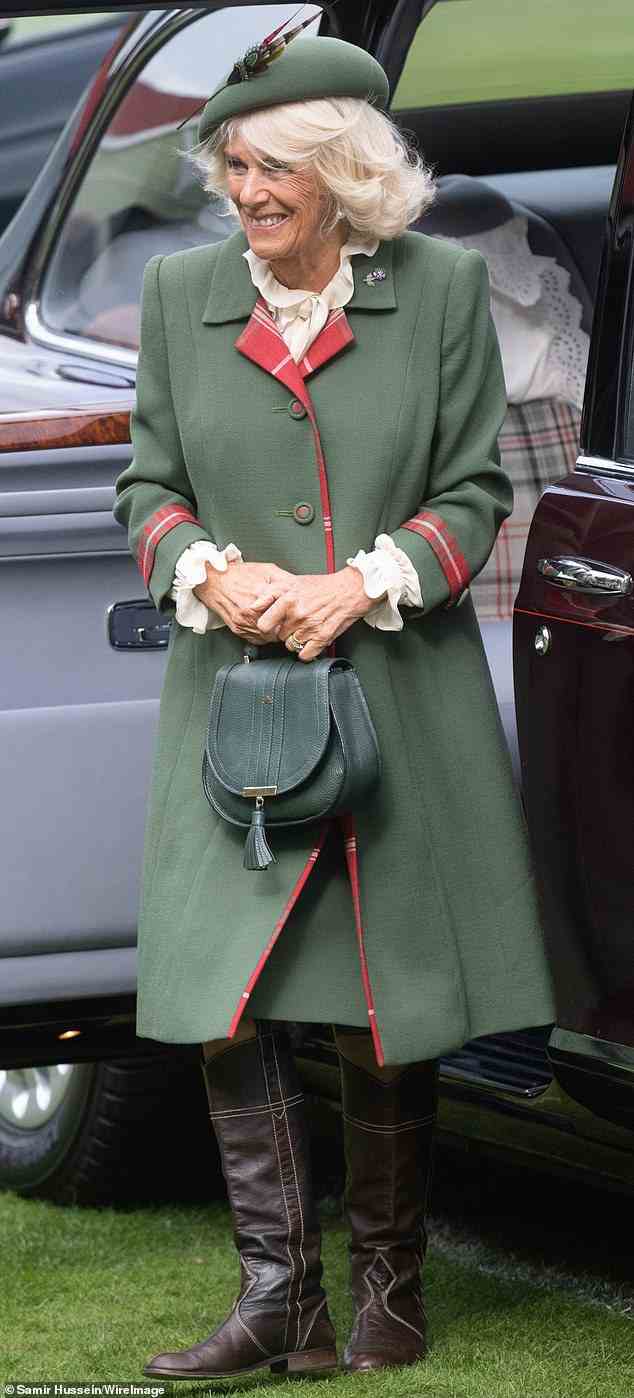 The royal opted to wear a green dress coat with a red tartan trim, alongside flat brown boots, and a green handbag