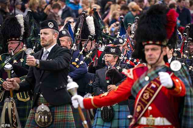 Pictured: The Massed Pipes and Drums parade in the arena during the Braemar Royal Highland Gathering in Braemar