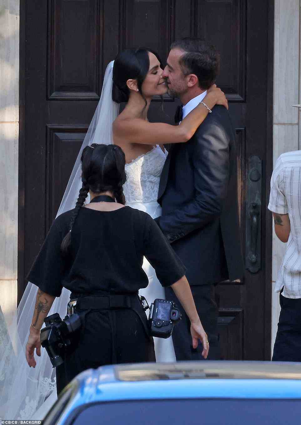 Locking lips: After exchanging their vows, the lovebirds shared a passionate kiss