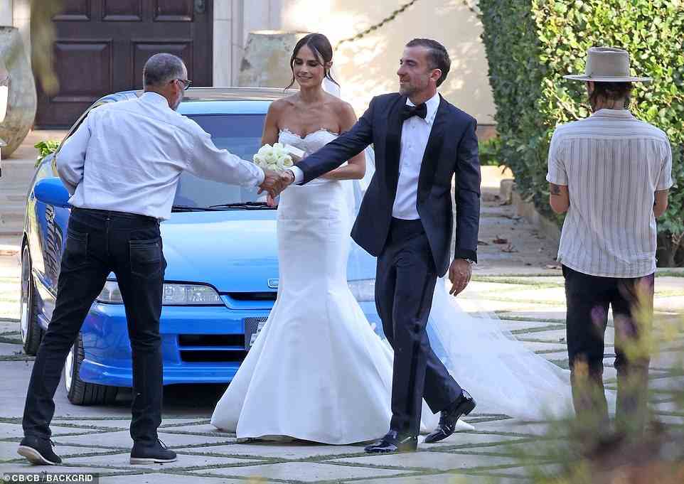 Shaking hands: The newlyweds looked cheerful as they mingled with their guests