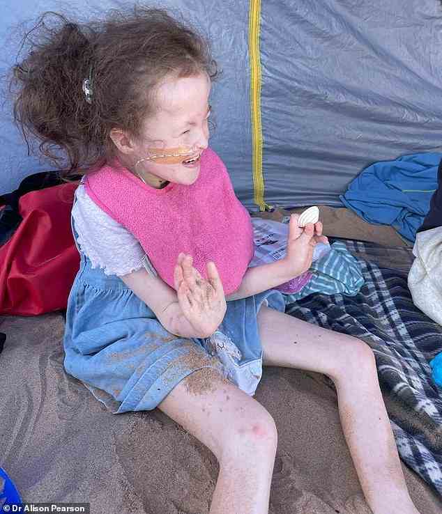 Isabel plays in the sand on a trip to the beach with her family, showcasing her infectious smile. Only about 13 in every 100 babies born alive with Edwards' syndrome will live past their first birthday
