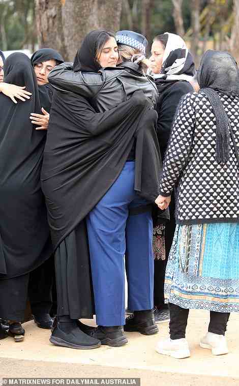 Constable Tanzeel Bashir's mother Rani was comforted by her son's grief-stricken colleagues at the funeral and burial