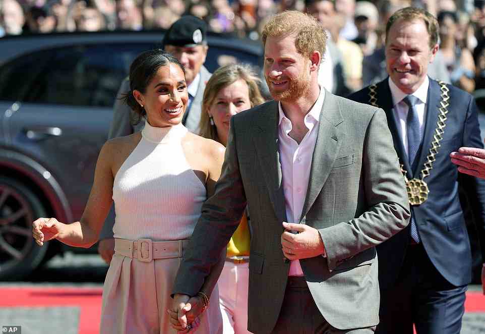 Harry and Meghan (pictured) will meet with officials and competitors at next year's event, which has been delayed due to the Covid pandemic, in Dusseldorf