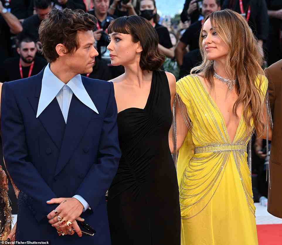 Look of love! Olivia Wilde shared a loving glance with her beau Harry Styles on Monday as she stunned in a yellow gown for her film Don't Worry Darling's Venice Film Festival premiere - there was no such shared look for the movie's leading lady, Florence Pugh