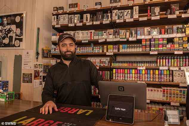 Tony Crafanakis, 35, owner of Caffe Vape, stands behind the bar where e-cigarettes don't need to be kept behind brandless shutters