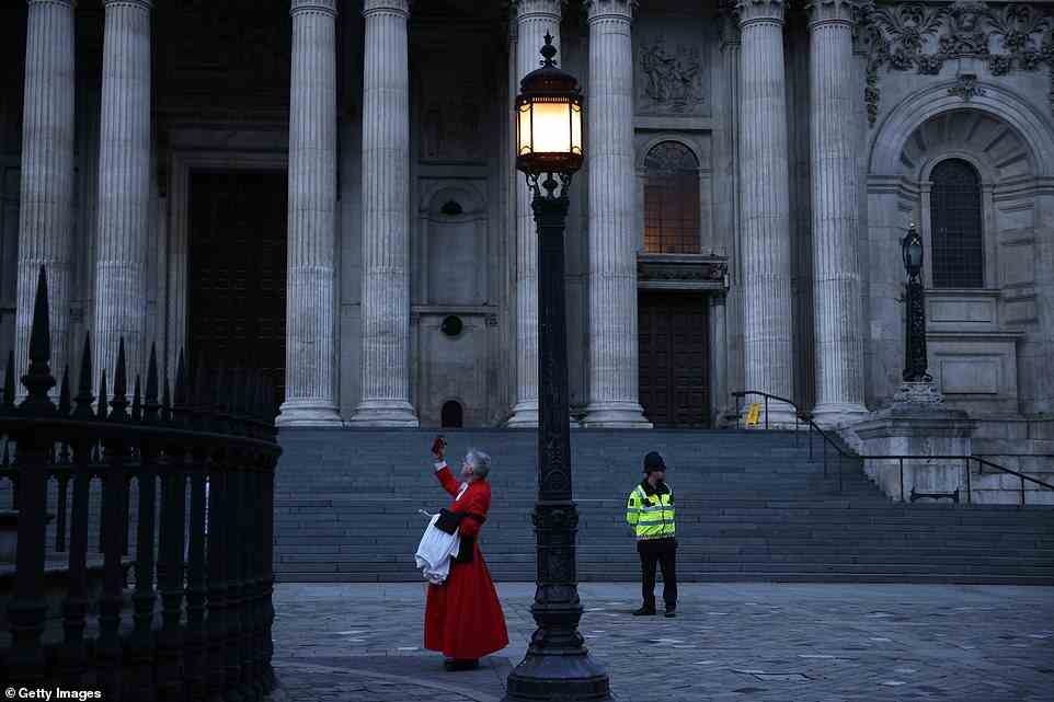 Mourners are seen leaving St Paul's Cathedral after the service of prayer and reflection