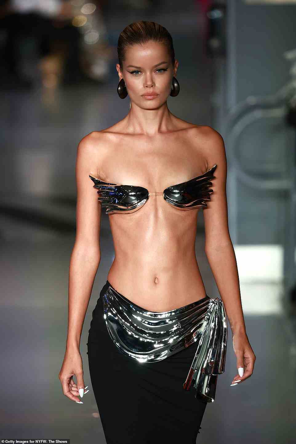 Angelic: Aasen's runway look left little to the imagination as she donned just a tiny chrome breast plate shaped like a pair of wings