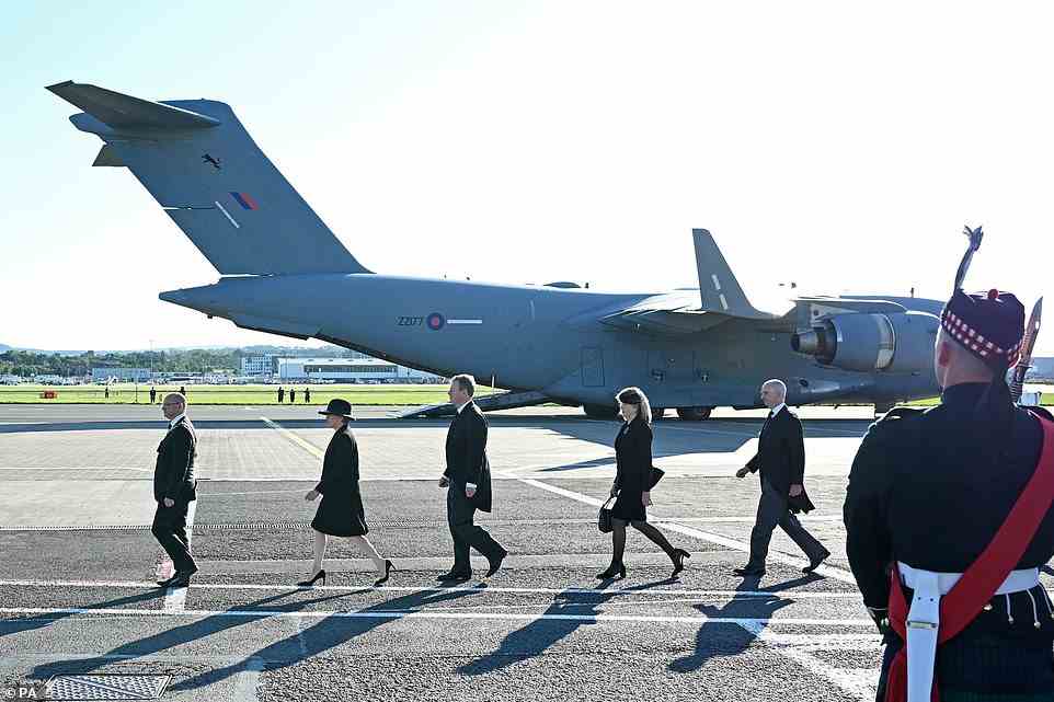 Dignitaries, including Scotland's First Minister Nicola Sturgeon (second left) and Scottish Secretary Alister Jack (centre) prepare for the arrival of the coffin of Queen Elizabeth II at Edinburgh Airport where it will be flown by plane on its journey to Buckingham Palace
