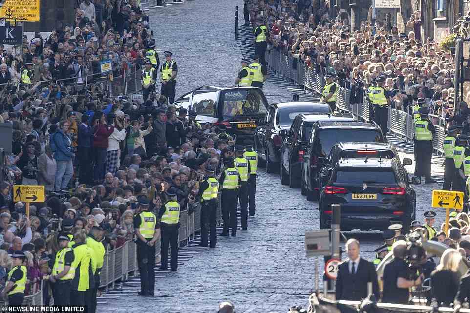 The Queen's coffin is carried in a hearse up the Royal Mile to Edinburgh Airport as a sea of mourners watches