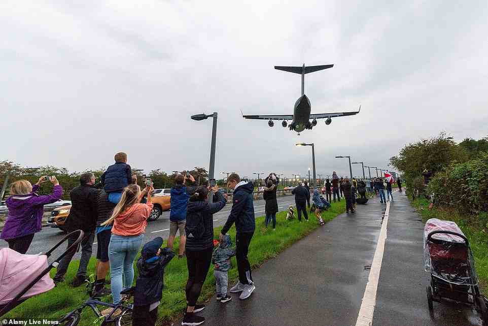 Mourners caught a glimpse of the RAF jet landing at Northolt in west London this evening