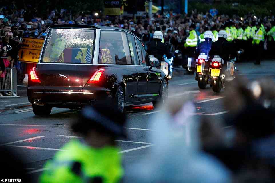 People watch the hearse carrying the coffin of Queen Elizabeth