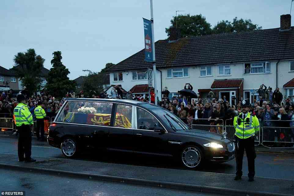 People watch the hearse carrying the coffin of Queen Elizabeth