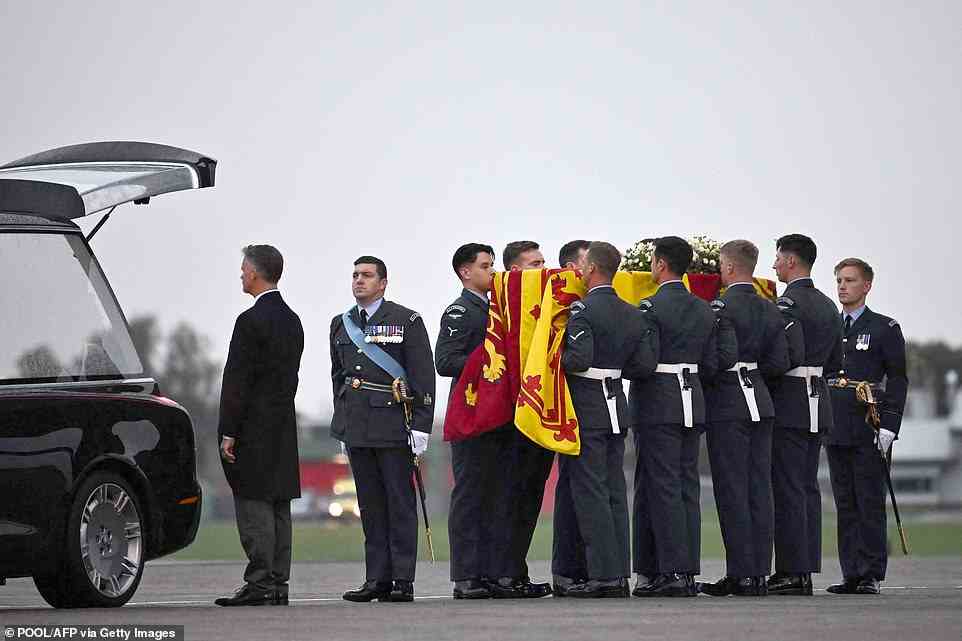 Pallbearers from the Queen's Colour Squadron (63 Squadron RAF Regiment) carry the coffin of Queen Elizabeth II to the Royal Hearse having removed it from the C-17 at Northolt