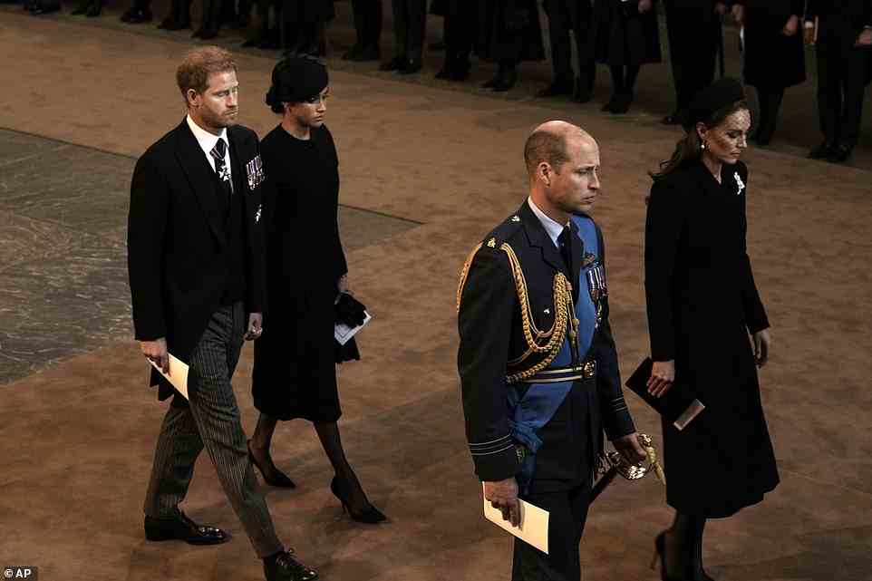 Harry and Meghan held hands as they followed William and Kate from the Hall