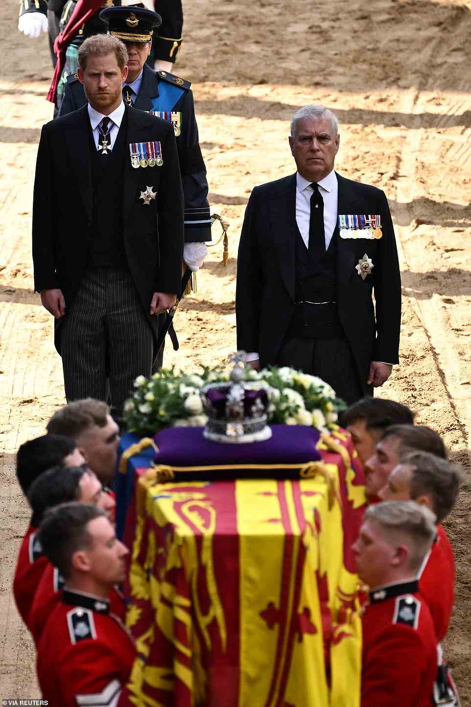 Prince Harry, Duke of Sussex (L) and Britain's Prince Andrew, Duke of York watch as pallbearers from The Queen's Company, 1st Battalion Grenadier Guards prepare to carry the coffin