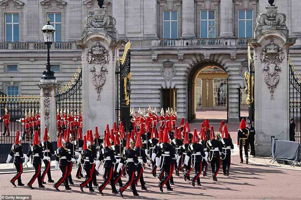 The Life Guard dismounted detachment of the Household Cavalry and the Dismounted detachment of the Blues and Royals are seen entering the gates of Buckingham Palace ahead of the procession for Queen Elizabeth II this afternoon