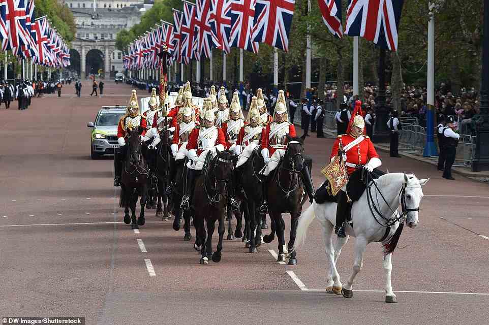 The Household Cavalry head along the Mall ahead of the procession carrying the Queen's coffin to Westminster today