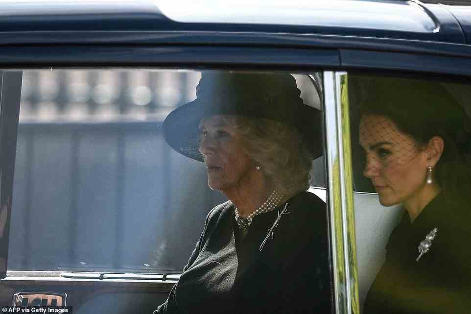 Meanwhile Queen Consort and Britain's Catherine, Princess of Wales are driven behind the coffin of Queen Elizabeth II, adorned with a Royal Standard and the Imperial State Crown and pulled by a Gun Carriage of The King's Troop Royal Horse Artillery, during a procession from Buckingham Palace to the Palace of Westminster, in London