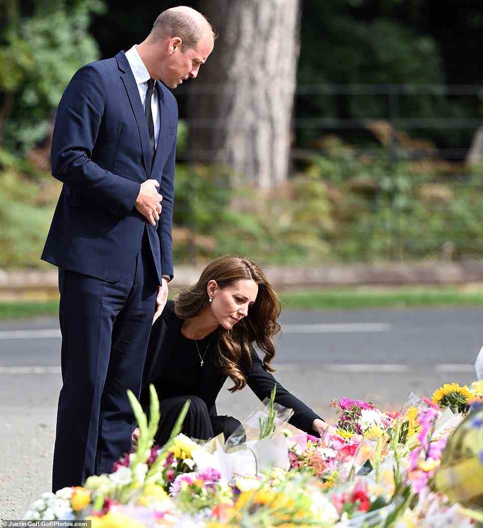 The Princess of Wales cuts a sombre figure as she closely inspects the sea of flowers left by mourners
