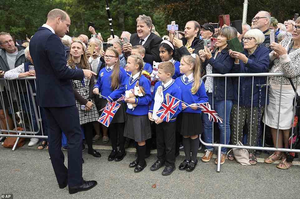 A group of schoolchildren from Howard Junior School, Norfolk excitedly waved flags bearing the Union Jack as they greeted Prince William outside Sandringham today
