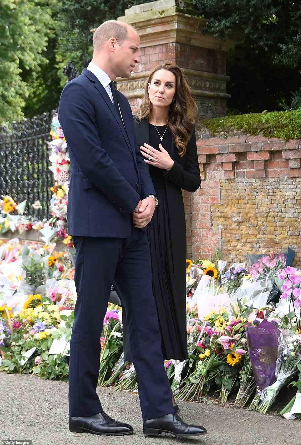 Prince William, Prince of Wales and Catherine, Princess of Wales, view floral tributes placed outside the Sandringham Estate following the death of Queen Elizabeth II