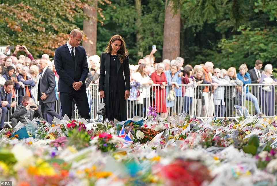 The royal couple spent a few minutes inspecting the vast piles of flowers that had been left outside the royal residence