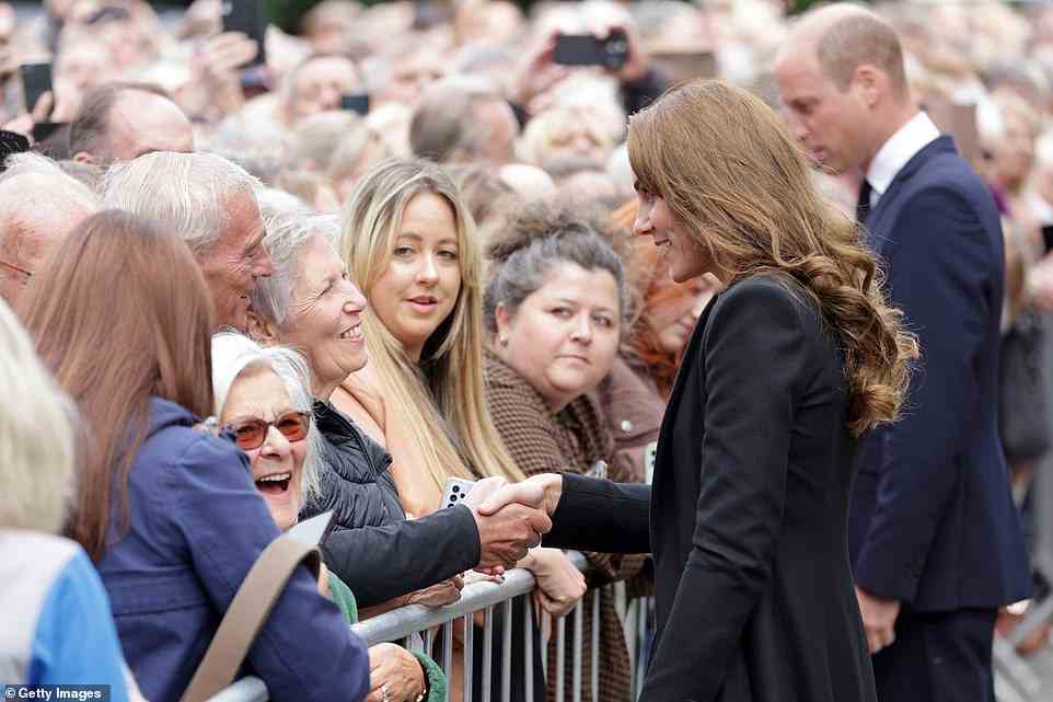 Kate shakes hands with a mourner at Sandringham today, where thousands of people turned out to meet them