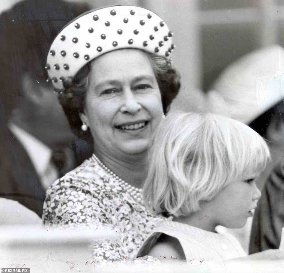 In this adorable photograph from 1984, the Queen took her young granddaughter Zara Phillips, aged three, onto her knee as they watched the polo at Smith's Lawn, Windsor. Then Zara sat on Grandma's knee to watch mother Princess Anne ride her horse in a display.