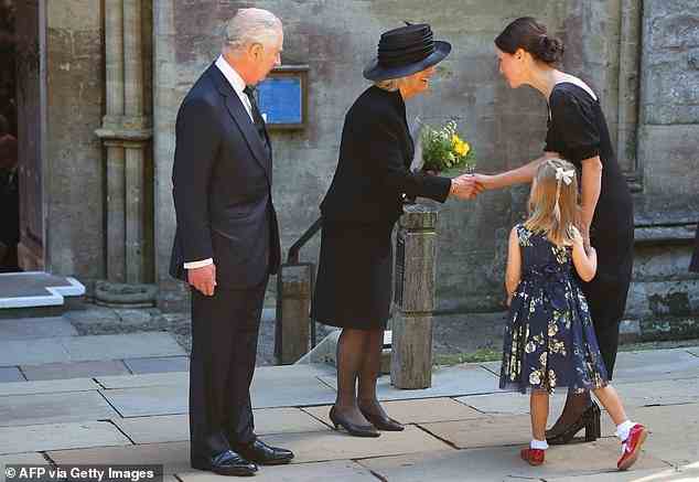 A little girl gave the Queen Consort a bouquet of flowers outside Llandaff Cathedral yesterday after King Charles arrived in Wales for the first time as monarch