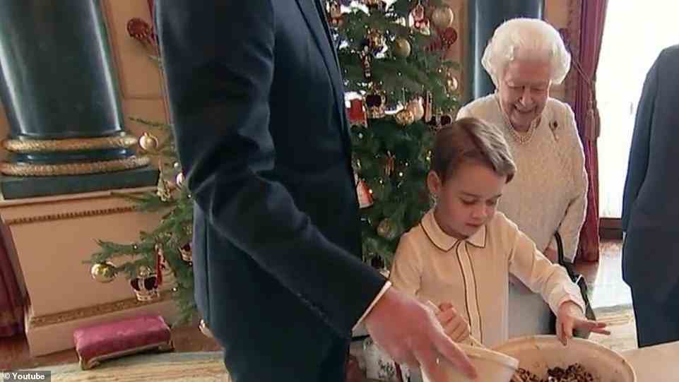 Prince George tries his hand at making Christmas pudding under the watchful eye of his great-grandmother the Queen for a video broadcast on Christmas Day 2019