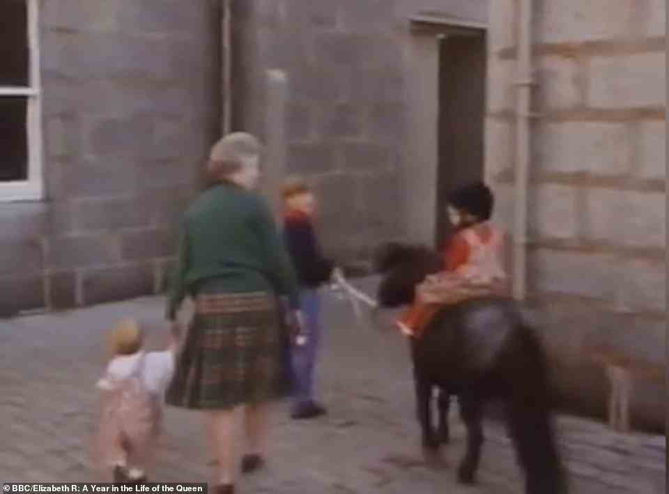 In the footage, taken in the grounds of Balmoral Castle, the Queen is joined by several of her grandchildren - including Prince William, then 10, Prince Harry, then eight, Zara Phillips, then 11 Princess Beatrice